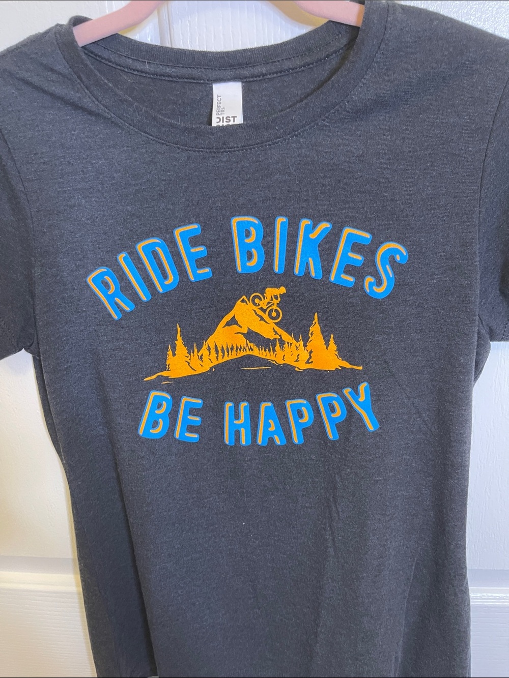 Black T-Shirt's front logo is "Ride Bikes Be Happy".